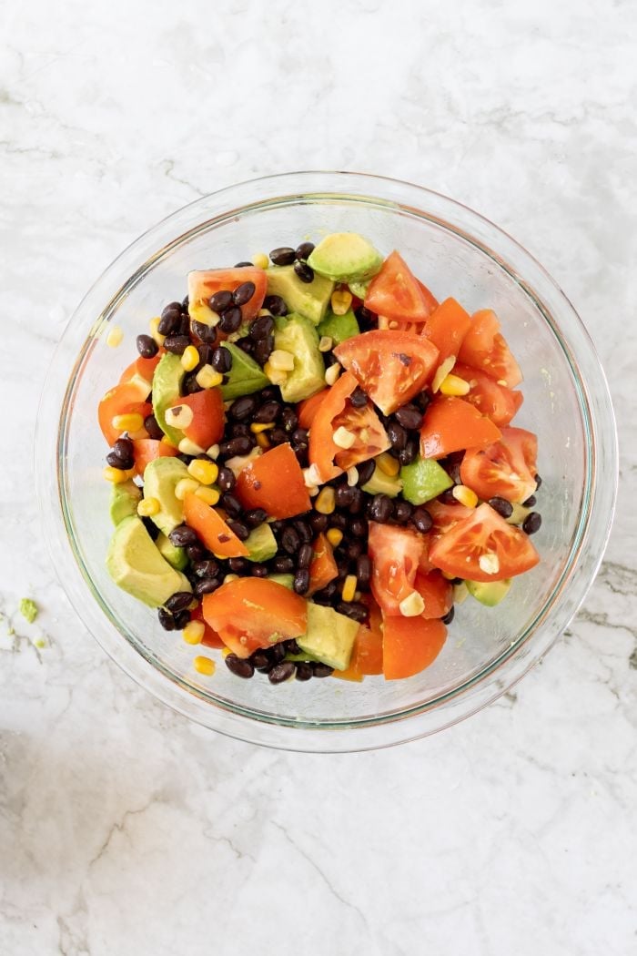 top down view showing the mixed salad ingredients in a large bowl